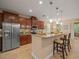 Kitchen with granite countertops, stainless steel appliances, a breakfast bar, and dark wood cabinetry at 27546 Stonecreek Way, Wesley Chapel, FL 33544
