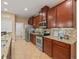 Well-lit kitchen with stainless steel appliances, granite countertops, and ample cabinet space at 27546 Stonecreek Way, Wesley Chapel, FL 33544