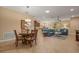 Open floor plan with living, dining and kitchen area, neutral colors, and tile flooring at 27546 Stonecreek Way, Wesley Chapel, FL 33544