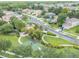 Aerial view of a Gathering-friendly neighborhood with a playground and basketball court surrounded by lush greenery at 27546 Stonecreek Way, Wesley Chapel, FL 33544