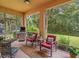 Relaxing screened patio with comfortable seating, an outdoor grill and a beautiful view of the lush greenery at 27546 Stonecreek Way, Wesley Chapel, FL 33544