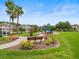 Community playground area with benches, lush landscaping, mature trees and nearby homes at 27546 Stonecreek Way, Wesley Chapel, FL 33544