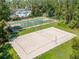 Aerial view showcasing the volleyball and basketball courts amidst lush landscaping at 27546 Stonecreek Way, Wesley Chapel, FL 33544