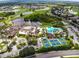 Aerial view of the community clubhouse, pool, tennis courts, and surrounding golf course at 301 Kings Blvd # 130, Sun City Center, FL 33573