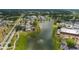 A beautiful aerial view of a community with a lake, fountain, pool, and clubhouse at 301 Kings Blvd # 130, Sun City Center, FL 33573