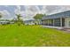 Wide view of a large, well-maintained green backyard area, highlighting the outdoor space of the property at 301 Kings Blvd # 130, Sun City Center, FL 33573
