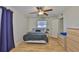 Bedroom with wood floors, ceiling fan, and a window providing natural light and comfortable living at 301 Kings Blvd # 130, Sun City Center, FL 33573