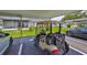 View of a carport featuring a golf cart and parked cars, highlighting the convenience of covered parking at 301 Kings Blvd # 130, Sun City Center, FL 33573