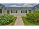 Charming condo with a walkway flanked by lush landscaping and symmetrical design at 301 Kings Blvd # 130, Sun City Center, FL 33573