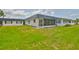 Well-maintained home exterior features a green lawn, screened in patio, and a inviting curb appeal at 301 Kings Blvd # 130, Sun City Center, FL 33573