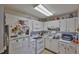 Well-lit kitchen with white cabinets, appliances, and an organized layout for cooking and storage at 301 Kings Blvd # 130, Sun City Center, FL 33573