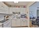 Bright kitchen with white cabinets, appliances, and a view into the adjacent office space at 301 Kings Blvd # 130, Sun City Center, FL 33573