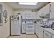 Functional kitchen features white cabinets, appliances, and ample counter space for meal preparation at 301 Kings Blvd # 130, Sun City Center, FL 33573