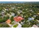 Expansive aerial view showcasing home surrounded by lush greenery near the water at 3107 S Emerson St, Tampa, FL 33629