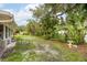 Large backyard with mature trees and tropical plants at 3107 S Emerson St, Tampa, FL 33629