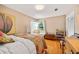 Cozy bedroom featuring a corner window seat, hardwood floors, and natural light at 3107 S Emerson St, Tampa, FL 33629