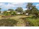 Exterior view of home showing large front yard with many trees at 3107 S Emerson St, Tampa, FL 33629