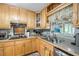 Cozy kitchen featuring light wood cabinets, neutral countertops, and a stainless steel sink at 3107 S Emerson St, Tampa, FL 33629