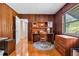 Wood paneled office featuring a built-in desk, and wood flooring at 3107 S Emerson St, Tampa, FL 33629