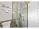 Walk in shower with glass door and neutral tile at 3107 S Emerson St, Tampa, FL 33629