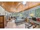 Bright sunroom with wood ceiling, tile floors, and large windows overlooking the backyard at 3107 S Emerson St, Tampa, FL 33629