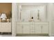 Modern bathroom with double vanity, sleek white cabinets, and contemporary fixtures at 32046 Griffin Sands Ln, San Antonio, FL 33576