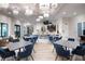 Clubhouse interior showing seating area with modern chandeliers and kitchen with bar seating at 32046 Griffin Sands Ln, San Antonio, FL 33576