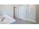 Main bathroom with double sinks, a walk-in closet, and a shower-tub combination at 32638 Osprey Peak Way, San Antonio, FL 33576