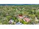 Aerial view of property highlighting its location among lush trees in the neighborhood at 327 Sunnyside Rd, Temple Terrace, FL 33617