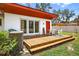 Wooden deck with outdoor seating and dining, great for enjoying the beautiful backyard views at 327 Sunnyside Rd, Temple Terrace, FL 33617