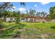 Well-maintained backyard features a lush lawn and mature trees providing ample shade at 327 Sunnyside Rd, Temple Terrace, FL 33617