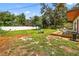 Spacious backyard with a large lawn and wooden deck, perfect for outdoor entertaining and relaxing at 327 Sunnyside Rd, Temple Terrace, FL 33617