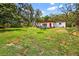 Expansive backyard featuring a lush lawn and mature trees providing privacy at 327 Sunnyside Rd, Temple Terrace, FL 33617