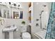 Bathroom featuring white tile, pedestal sink, and shower/tub combo with tile surround at 327 Sunnyside Rd, Temple Terrace, FL 33617