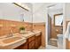 Charming bathroom features double sinks, a large mirror, and adjacent toilet area at 327 Sunnyside Rd, Temple Terrace, FL 33617