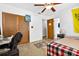 Cozy bedroom featuring a ceiling fan, closet and adjacent bathroom access at 327 Sunnyside Rd, Temple Terrace, FL 33617