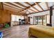 Bedroom boasting wood paneling, beamed ceiling and glass doors leading to the backyard at 327 Sunnyside Rd, Temple Terrace, FL 33617