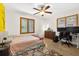 Versatile bedroom featuring a ceiling fan, large windows and space for relaxation and productivity at 327 Sunnyside Rd, Temple Terrace, FL 33617