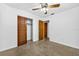 A tidy bedroom with a ceiling fan and closet offers ample storage space at 327 Sunnyside Rd, Temple Terrace, FL 33617