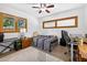 Functional bedroom furnished with a bed, desk, and keyboard for work or creativity at 327 Sunnyside Rd, Temple Terrace, FL 33617