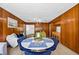 Cozy dining area with wood-paneled walls, a round table, and bright natural light at 327 Sunnyside Rd, Temple Terrace, FL 33617