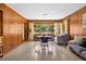 Cozy dining area with wood-paneled walls, a round table, and lots of natural light at 327 Sunnyside Rd, Temple Terrace, FL 33617