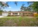 Beautiful single-story home with red shutters, brick facade, and a two-car garage at 327 Sunnyside Rd, Temple Terrace, FL 33617