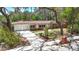 Charming single-story home featuring a red brick facade, white exterior, and manicured landscaping at 327 Sunnyside Rd, Temple Terrace, FL 33617