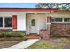 Inviting front entrance with decorative glass door, brick accents, and a 'Welcome' mat at 327 Sunnyside Rd, Temple Terrace, FL 33617