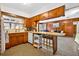 Cozy eat-in kitchen featuring wood cabinets, updated appliances and a convenient breakfast bar at 327 Sunnyside Rd, Temple Terrace, FL 33617