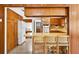 Open-concept kitchen and dining area with natural wood and eat-in breakfast bar at 327 Sunnyside Rd, Temple Terrace, FL 33617
