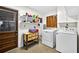Bright laundry room equipped with washer, dryer, and storage shelves at 327 Sunnyside Rd, Temple Terrace, FL 33617
