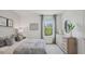 Serene bedroom with soft natural light, a comfortable bed, and a stylish dresser for restful nights at 33042 Osprey Peak Way, San Antonio, FL 33576
