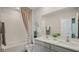 Bright bathroom with double sinks, a shower-tub combo, and neutral decor at 33072 Osprey Peak Way, San Antonio, FL 33576